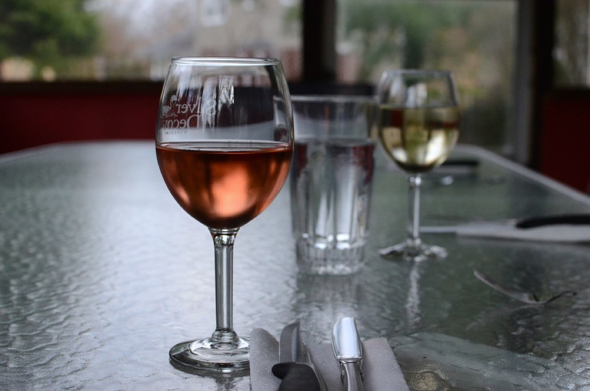 A professional shot of a red wine bottle and filled glass