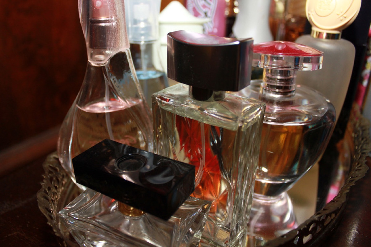 wine bottle collection in glass display case with labels